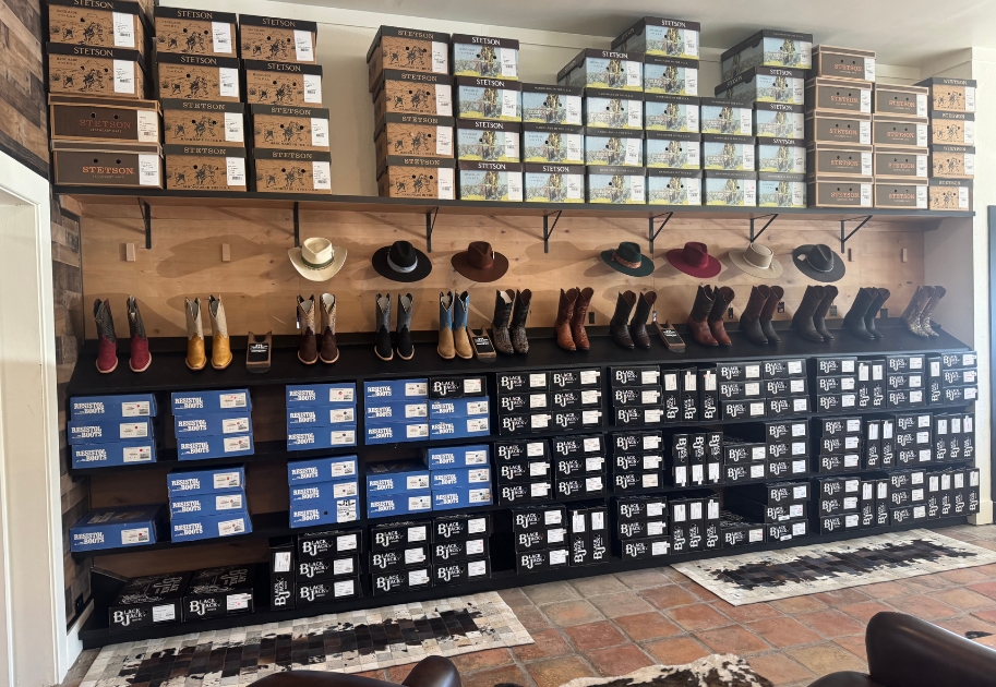 Custom boot rack at The McKinney Hat Company holding Stetson inventory